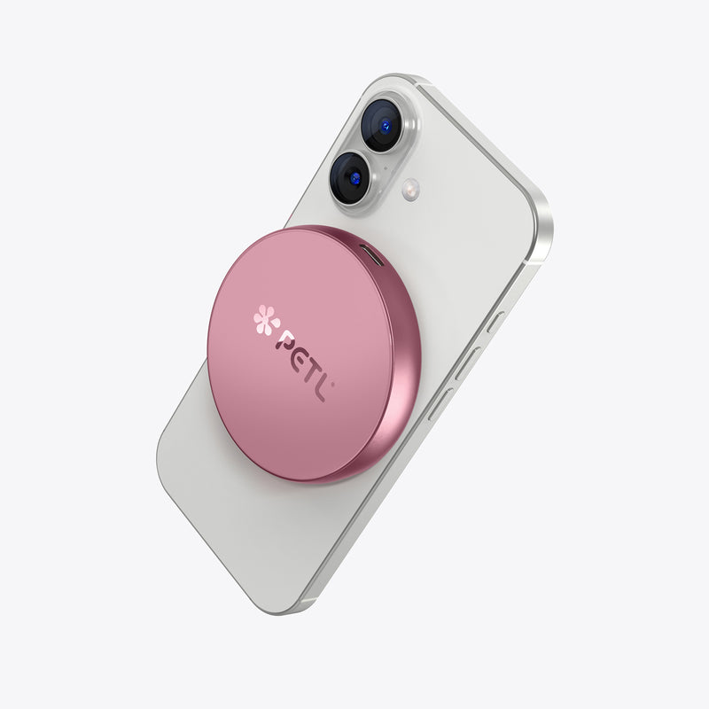 White iPhone with pink PETL MagSafe battery pack attached to the back.