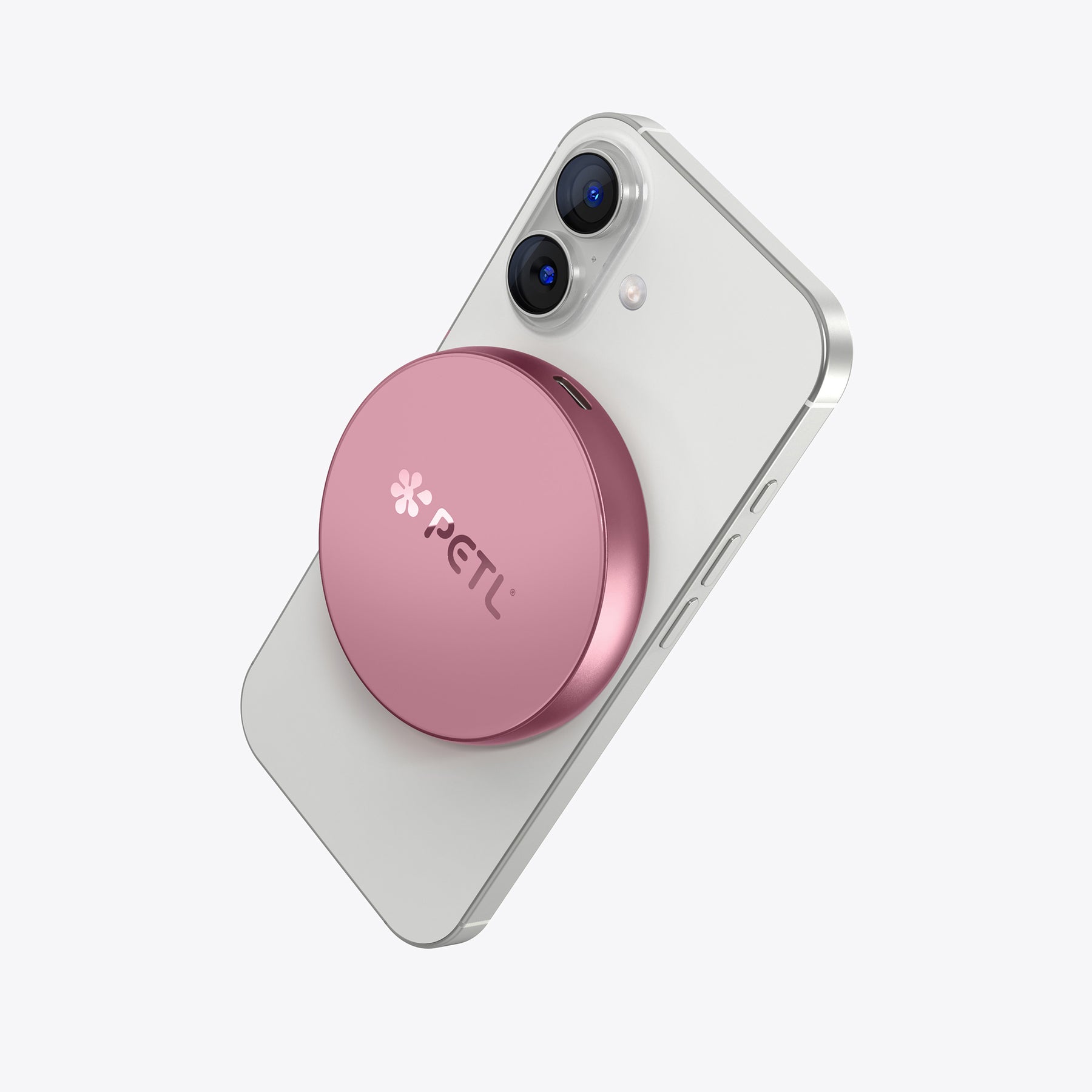White iPhone with pink PETL MagSafe battery pack attached to the back.