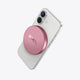 White iPhone with pink PETL MagSafe battery pack attached to the back.