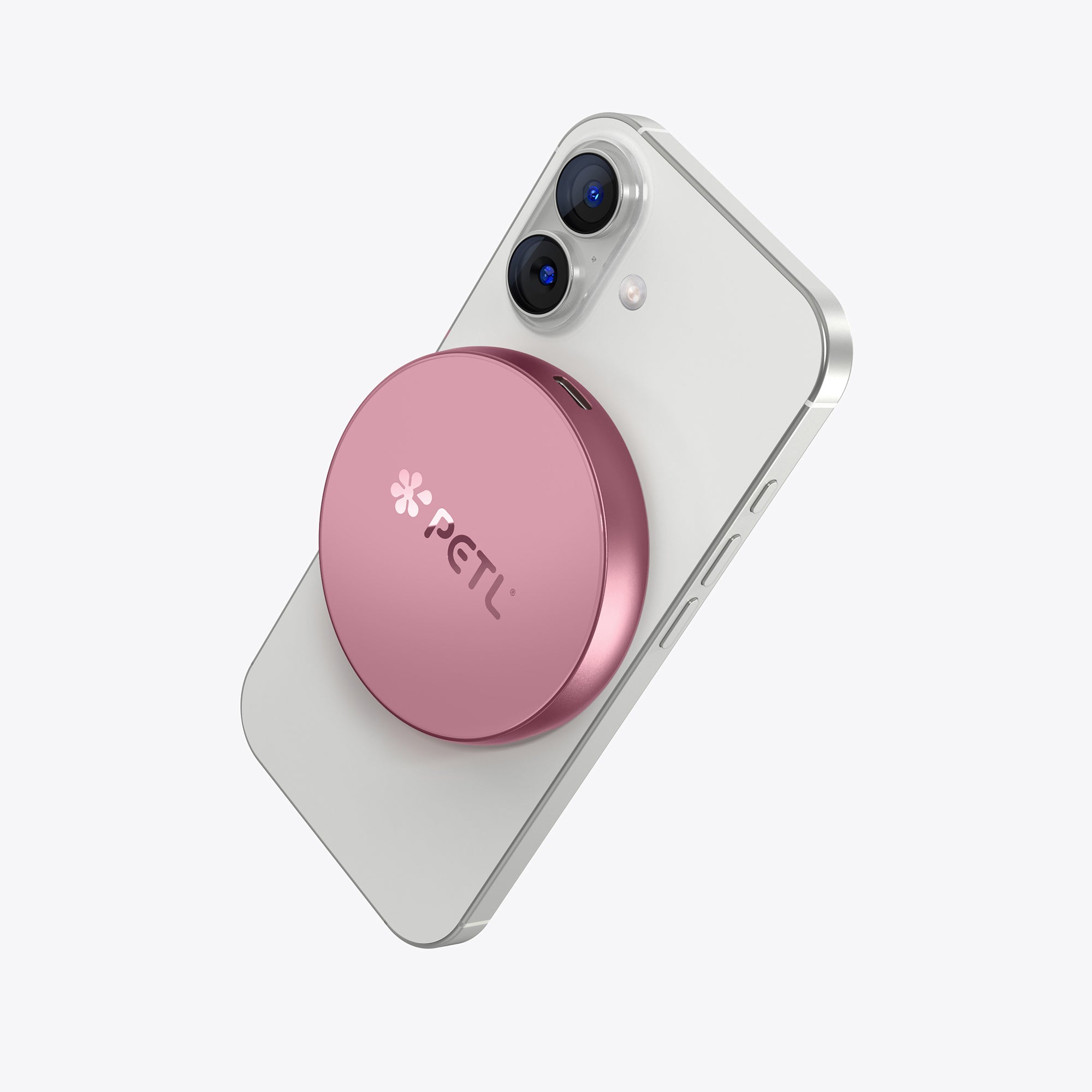 White iPhone with pink PETL MagSafe battery pack attached to the back.